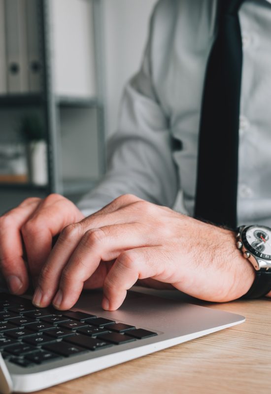 Professional accountant and tax adviser working on laptop computer in business office