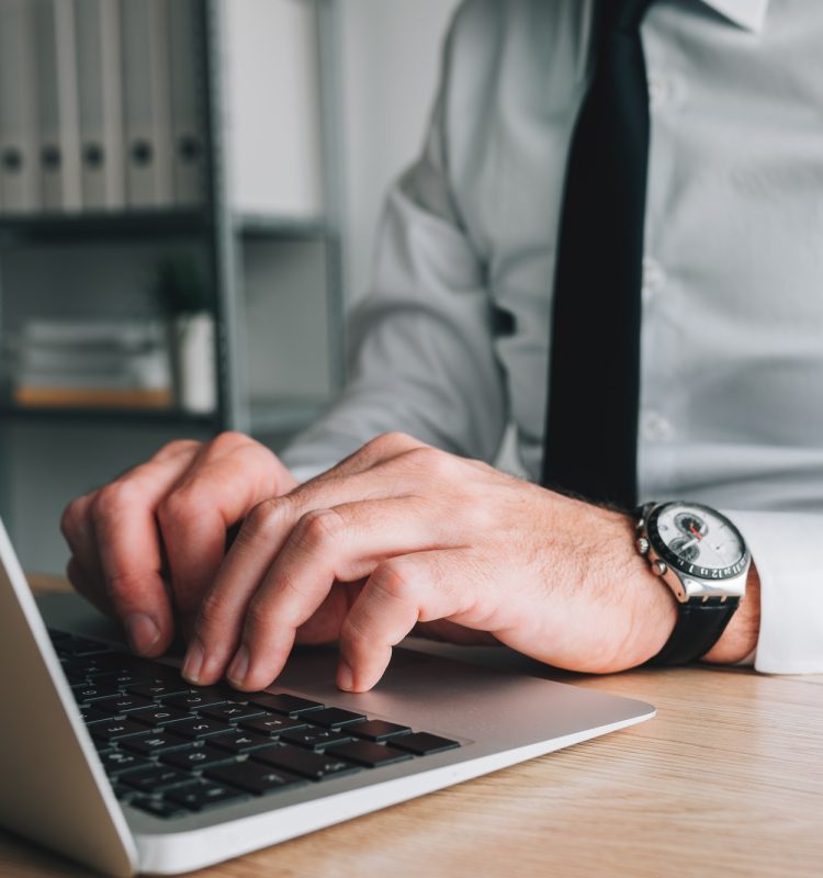 Professional accountant and tax adviser working on laptop computer in business office